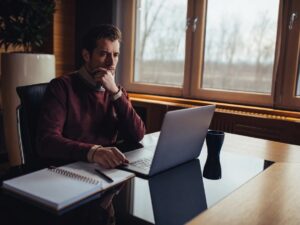 Man researches how to choose the right plants for his landscape design